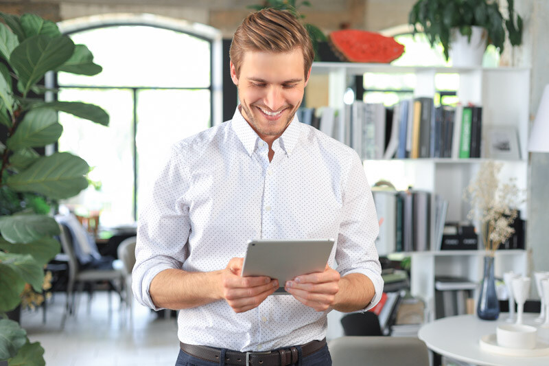 handsome-businessman-using-his-tablet-office