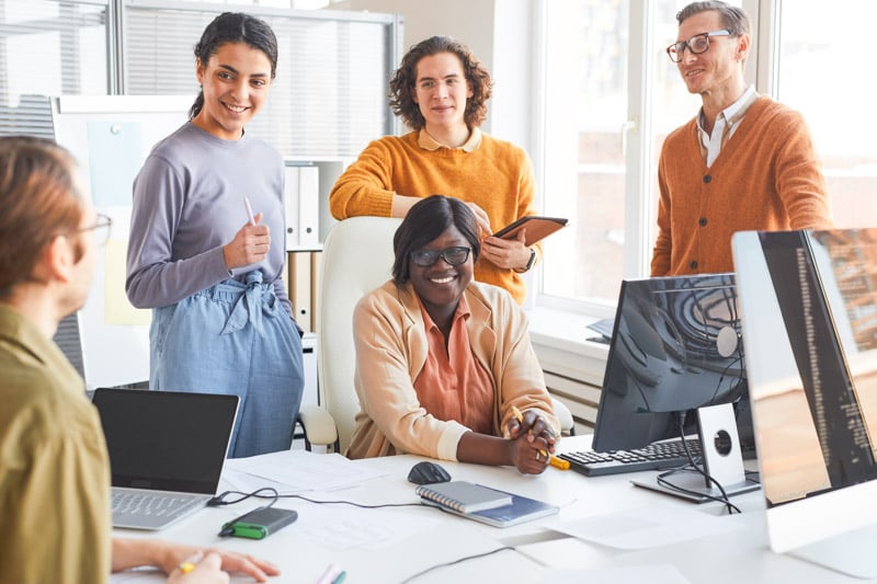 portrait-diverse-it-development-team-discussing-project-smiling-while-enjoying-work-software-production-studio-2