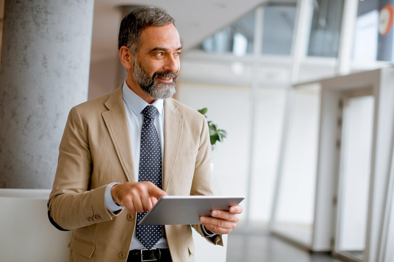 portrait-handsome-mature-businessman-with-digital-tablet-office