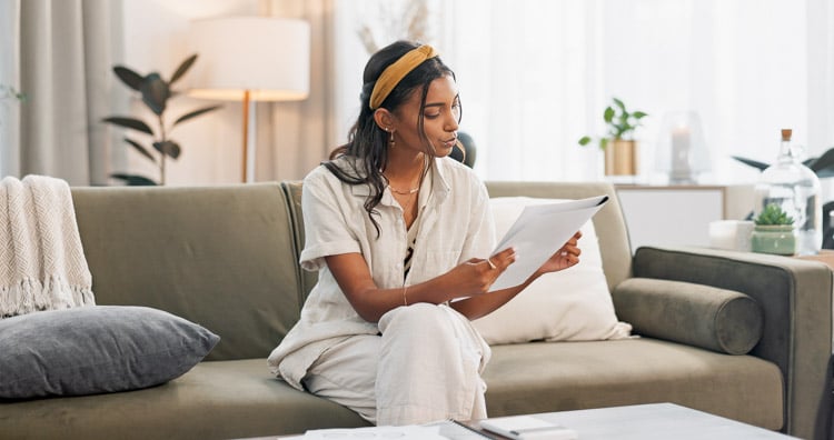 woman-reading-documents-home-remote-work-productivity